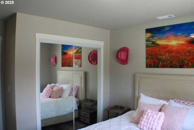 bedroom featuring a closet and visible vents