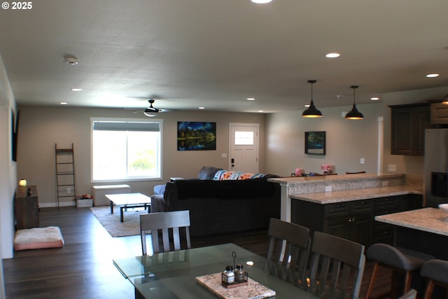 dining area with dark wood-style flooring, a wealth of natural light, and recessed lighting