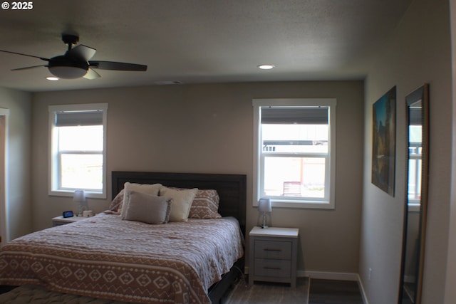 bedroom featuring visible vents, baseboards, a ceiling fan, recessed lighting, and wood finished floors