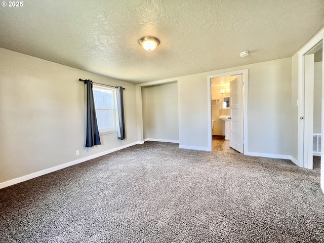 955 SW 10th St, Hermiston, OR 97838 - unfurnished bedroom with a textured ceiling, carpet, and ensuite bathroom