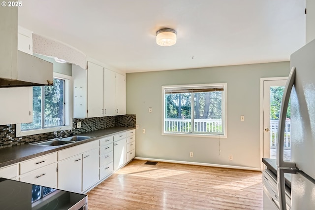 819 Oak St, Silverton, OR 97381 - kitchen with a sink, freestanding refrigerator, a wealth of natural light, and dark countertops