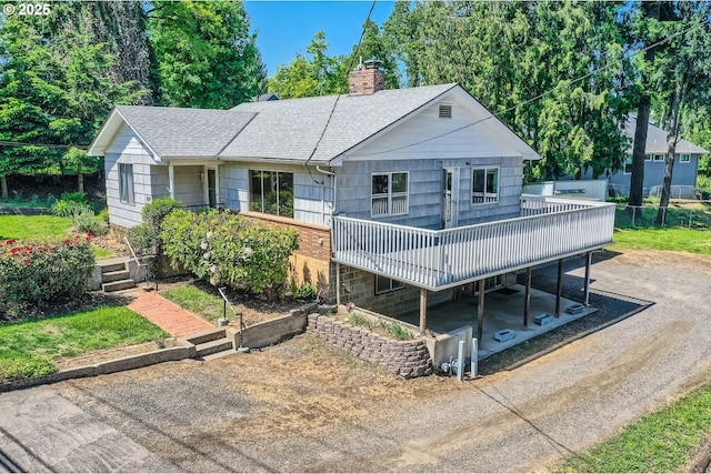 819 Oak St, Silverton, OR 97381 - view of front facade featuring roof with shingles, a chimney, and a deck