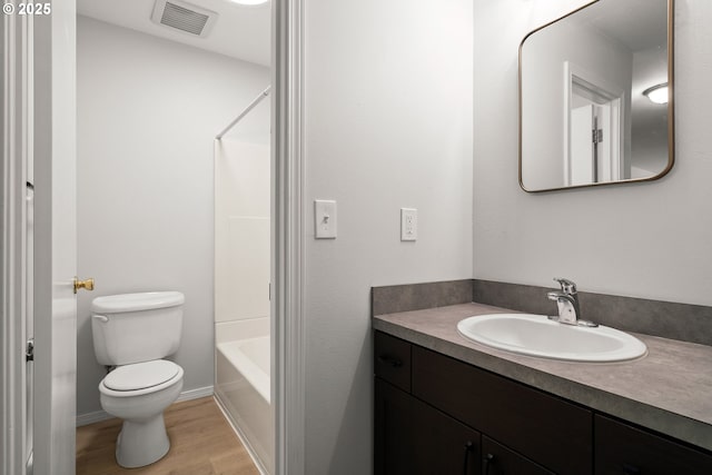 full bathroom with vanity, toilet, shower / bath combination, and hardwood / wood-style flooring