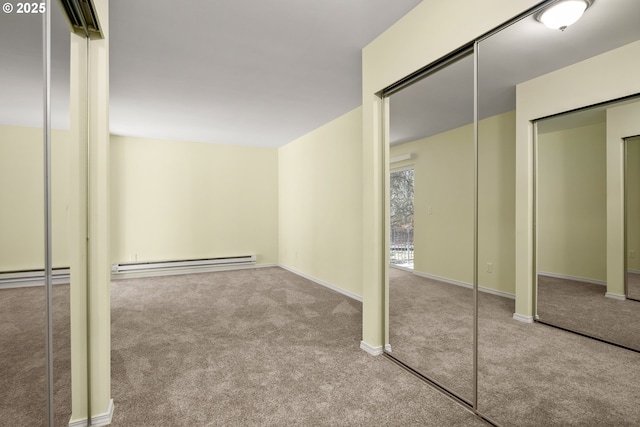 interior space featuring light colored carpet and a baseboard heating unit