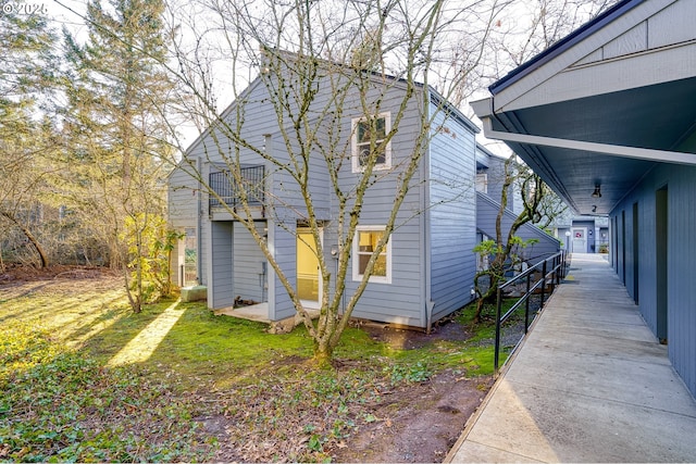 exterior space with a balcony and a front lawn