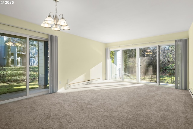 spare room with a chandelier and carpet