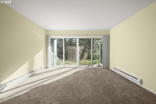 spare room featuring baseboard heating and carpet