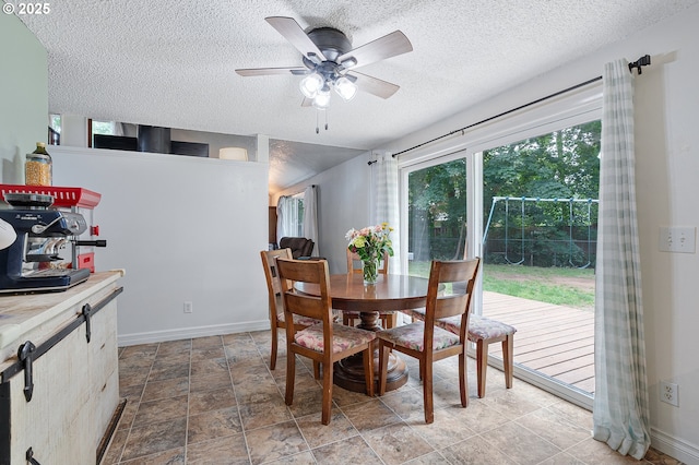 1354 Mulligan Ct, Salem, OR 97306 - dining room with a textured ceiling, ceiling fan, baseboards, and light stone finish flooring