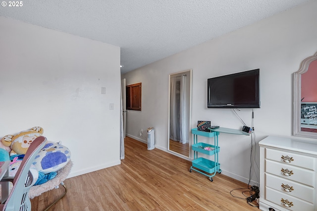 1354 Mulligan Ct, Salem, OR 97306 - bedroom featuring light wood finished floors, a textured ceiling, and baseboards
