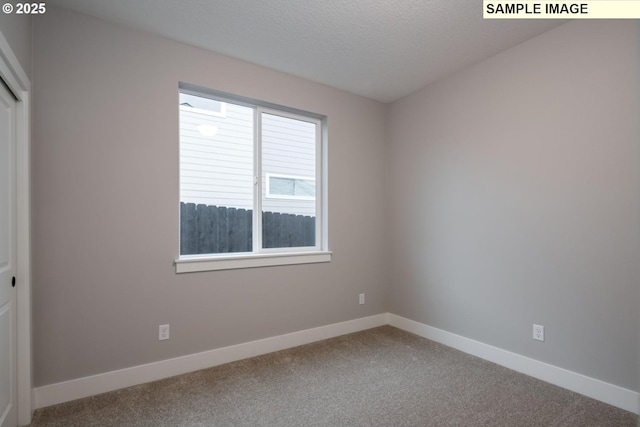 unfurnished bedroom with a textured ceiling, a closet, baseboards, and carpet flooring