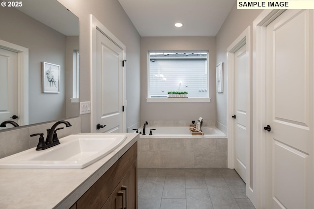 full bathroom with tile patterned flooring, a bath, and vanity