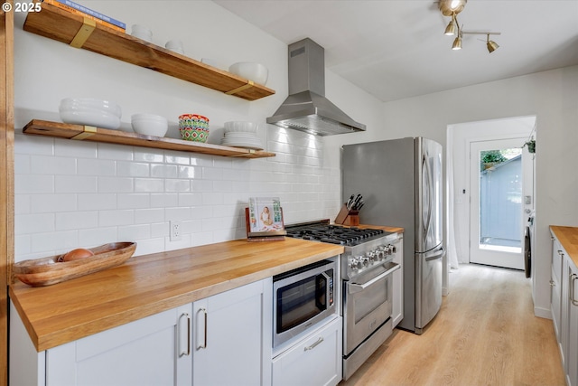 9014 N John Ave, Portland, OR 97203 - kitchen with island range hood, wood counters, appliances with stainless steel finishes, and light wood-style flooring