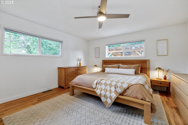 9014 N John Ave, Portland, OR 97203 - bedroom with light wood-style floors, multiple windows, and a ceiling fan
