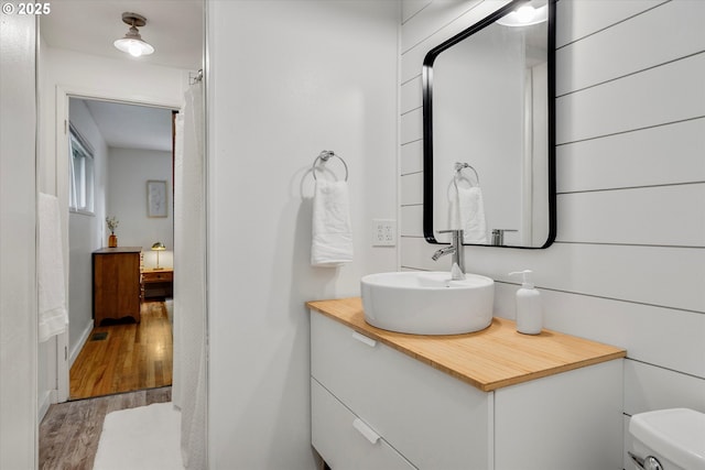 9014 N John Ave, Portland, OR 97203 - bathroom with vanity, wood finished floors, and toilet