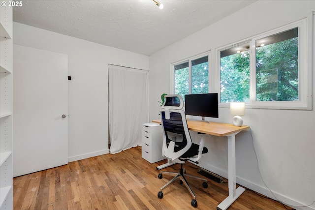 9014 N John Ave, Portland, OR 97203 - home office featuring light wood-style flooring, baseboards, and a textured ceiling