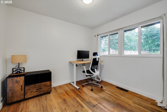 9014 N John Ave, Portland, OR 97203 - office space featuring wood finished floors, baseboards, and a textured ceiling