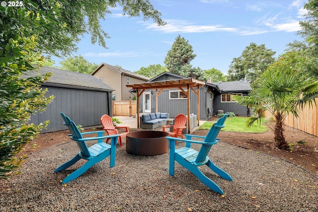 9014 N John Ave, Portland, OR 97203 - back of property with an outdoor fire pit, a fenced backyard, a pergola, and an outdoor structure