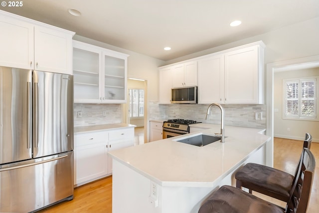 2435 NW Burnett St, Portland, OR 97229 - kitchen with appliances with stainless steel finishes, light countertops, light wood finished floors, backsplash, and recessed lighting
