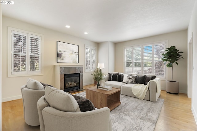 2435 NW Burnett St, Portland, OR 97229 - living area with a high end fireplace, recessed lighting, and light wood finished floors