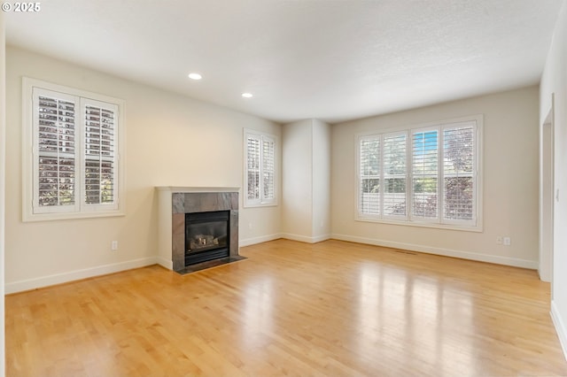 2435 NW Burnett St, Portland, OR 97229 - unfurnished living room with wood finished floors, a fireplace, and recessed lighting