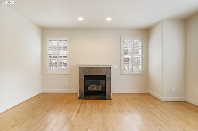 2435 NW Burnett St, Portland, OR 97229 - unfurnished living room featuring a fireplace, wood finished floors, and recessed lighting