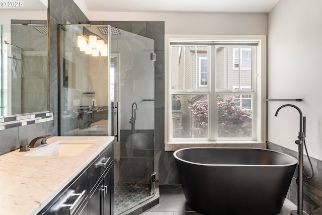 2435 NW Burnett St, Portland, OR 97229 - full bath featuring vanity, a freestanding tub, a stall shower, tile walls, and decorative backsplash