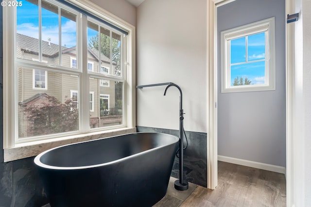 2435 NW Burnett St, Portland, OR 97229 - full bathroom with wood finished floors and a freestanding tub
