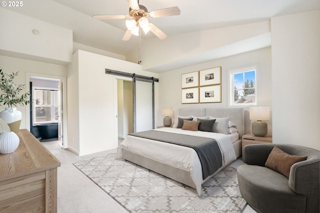 2435 NW Burnett St, Portland, OR 97229 - bedroom with a barn door, light colored carpet, lofted ceiling, and ceiling fan