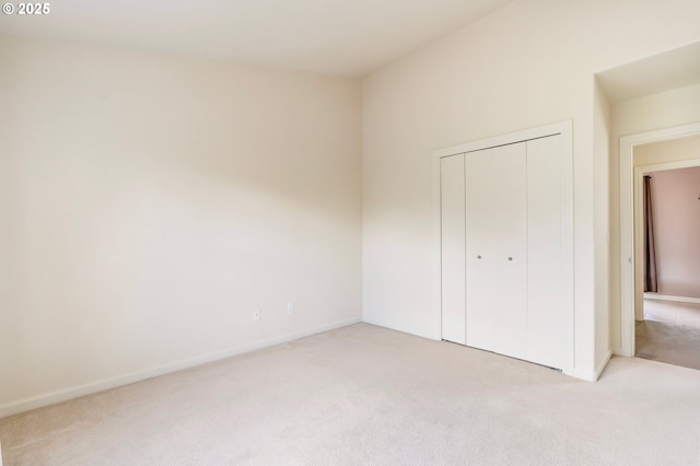 2435 NW Burnett St, Portland, OR 97229 - unfurnished bedroom featuring light carpet and a closet