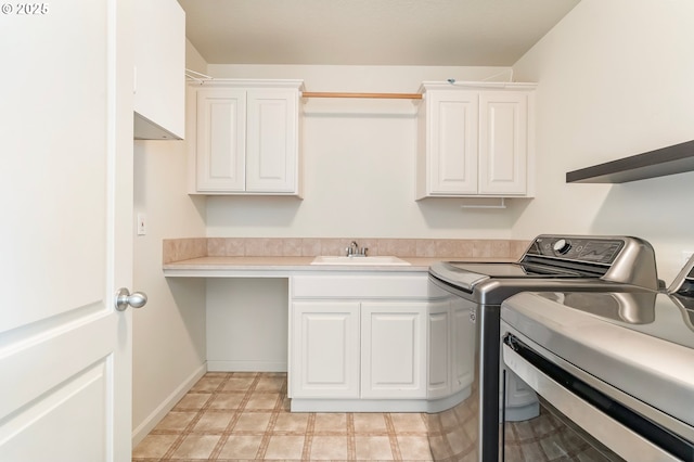 2435 NW Burnett St, Portland, OR 97229 - washroom with separate washer and dryer, cabinet space, and light floors