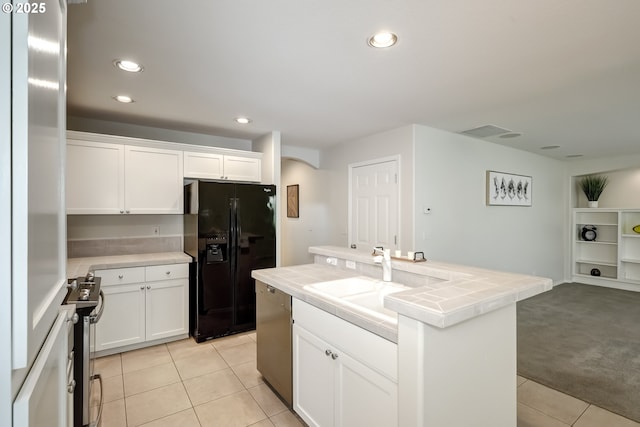 555 NE Caden Ave, Hillsboro, OR 97124 - kitchen with stainless steel appliances, tile countertops, a sink, light tile patterned flooring, and white cabinetry