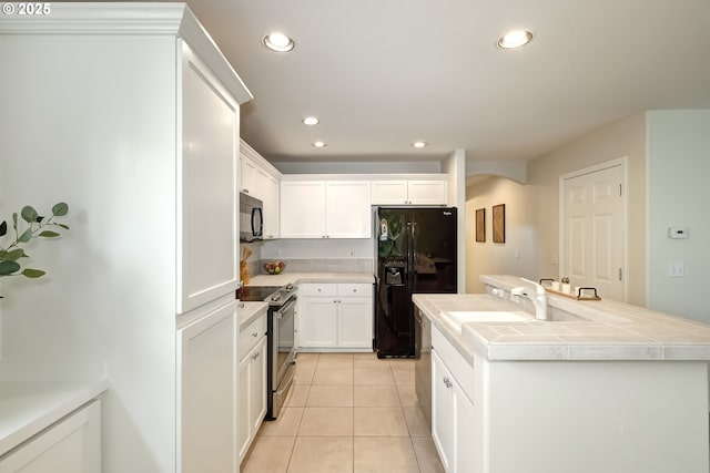 555 NE Caden Ave, Hillsboro, OR 97124 - kitchen with black appliances, tile countertops, a sink, recessed lighting, and light tile patterned floors
