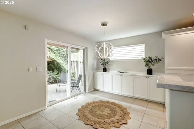 555 NE Caden Ave, Hillsboro, OR 97124 - unfurnished dining area featuring light tile patterned flooring, baseboards, and a chandelier