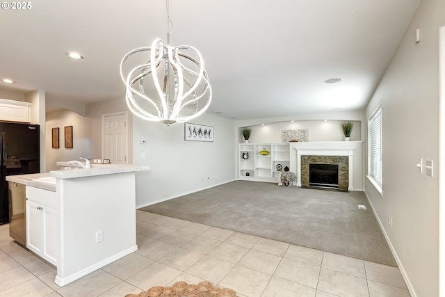 555 NE Caden Ave, Hillsboro, OR 97124 - kitchen with light carpet, freestanding refrigerator, white cabinets, a chandelier, and light countertops
