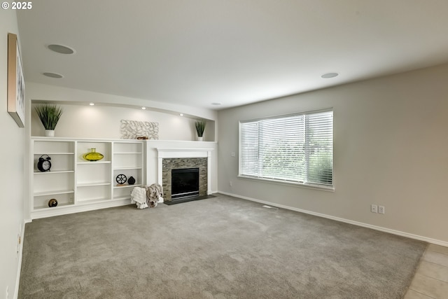 555 NE Caden Ave, Hillsboro, OR 97124 - unfurnished living room featuring a fireplace with flush hearth, baseboards, and carpet