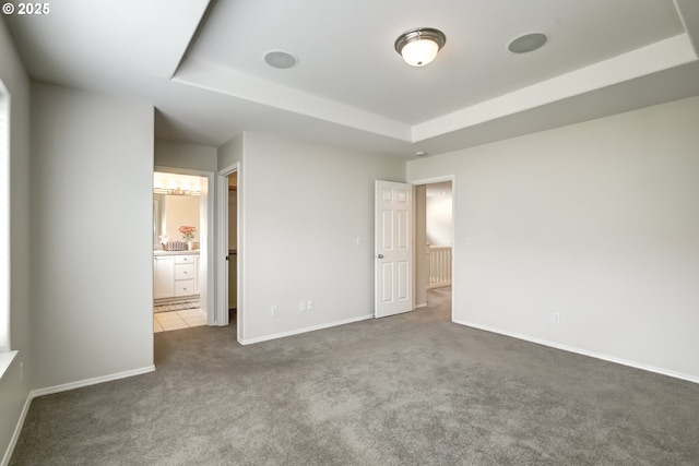 555 NE Caden Ave, Hillsboro, OR 97124 - unfurnished bedroom with carpet flooring, a raised ceiling, baseboards, and ensuite bathroom