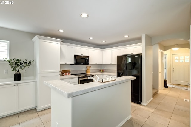555 NE Caden Ave, Hillsboro, OR 97124 - kitchen featuring black appliances, arched walkways, light tile patterned floors, white cabinetry, and recessed lighting