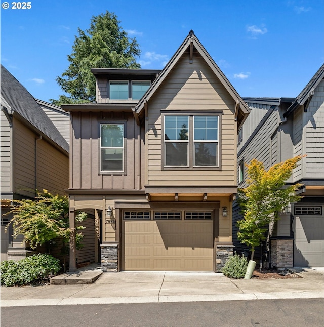 7886 SW Capitol Hill Rd, Portland, OR 97219 - view of front of home with board and batten siding, stone siding, an attached garage, and concrete driveway