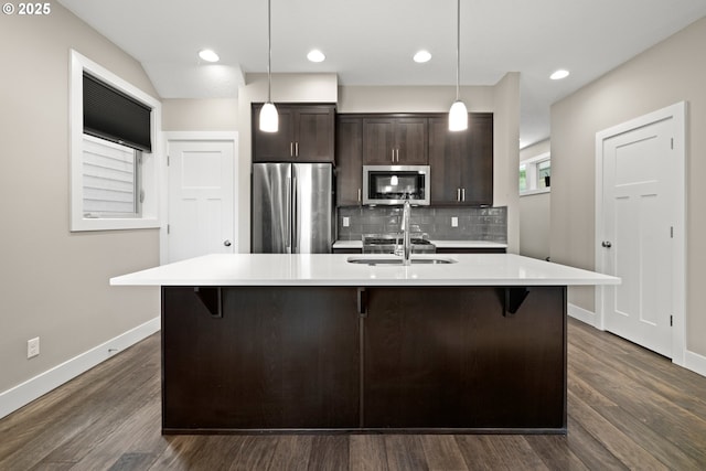 7886 SW Capitol Hill Rd, Portland, OR 97219 - kitchen featuring stainless steel appliances, dark brown cabinets, a kitchen breakfast bar, light countertops, and recessed lighting