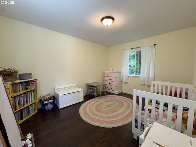 bedroom featuring baseboards and wood finished floors