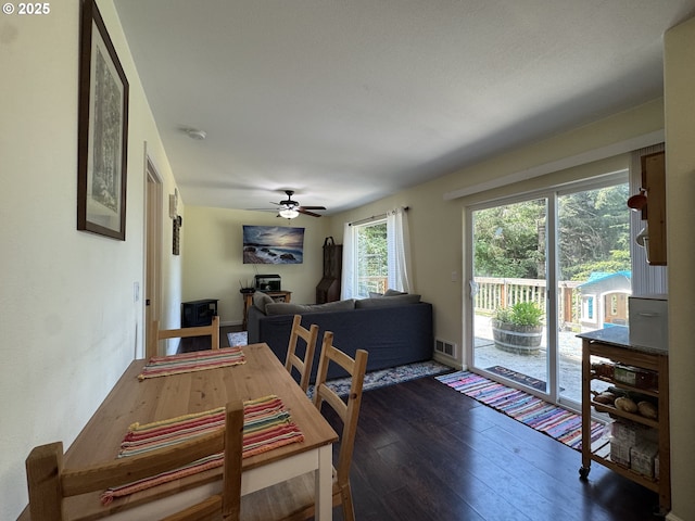 dining area featuring a ceiling fan, visible vents, and hardwood / wood-style floors