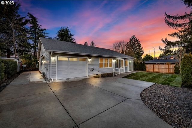 view of front of property featuring a garage and a yard