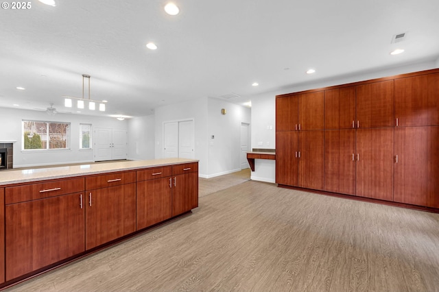 kitchen featuring hanging light fixtures and light hardwood / wood-style flooring