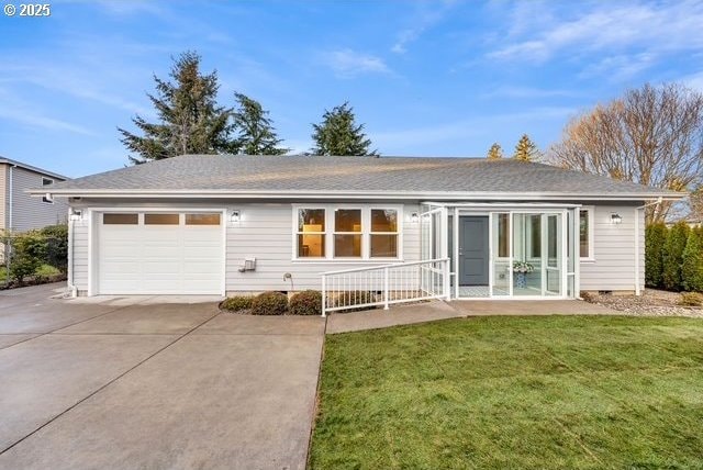 back of property featuring a yard and a garage