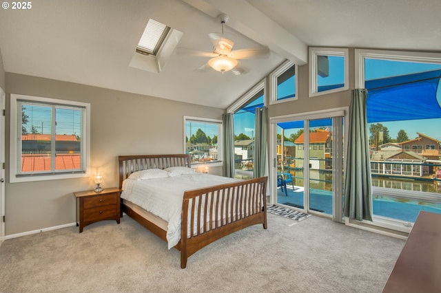 18989 NE Marine Dr Unit 04, Portland, OR 97230 - bedroom with access to outside, a skylight, carpet floors, baseboards, and a ceiling fan
