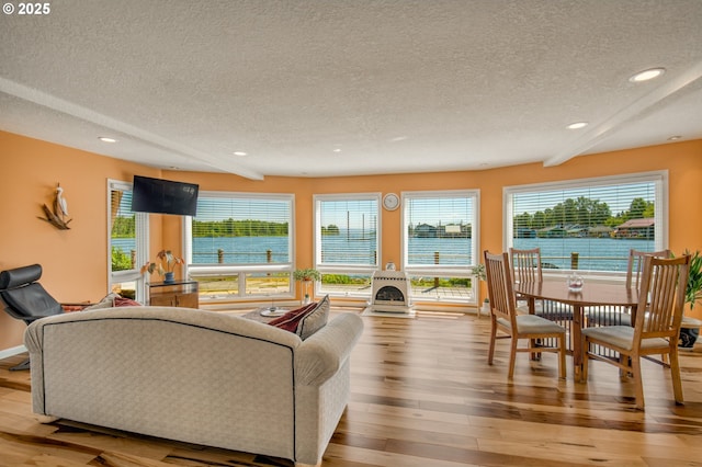 18989 NE Marine Dr Unit 04, Portland, OR 97230 - living room with a textured ceiling, wood finished floors, and recessed lighting