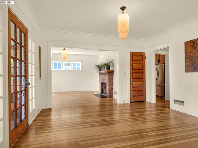 1925 Irving Ave, Astoria, OR 97103 - unfurnished living room featuring wood finished floors, crown molding, a fireplace, and french doors