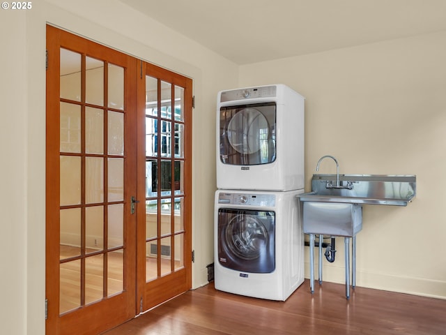 1925 Irving Ave, Astoria, OR 97103 - laundry room with stacked washer and clothes dryer, french doors, and wood finished floors