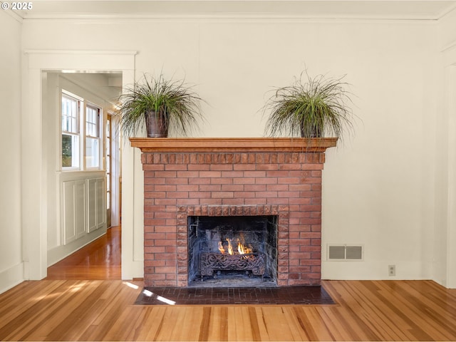 1925 Irving Ave, Astoria, OR 97103 - detailed view of wood finished floors, a brick fireplace, and ornamental molding