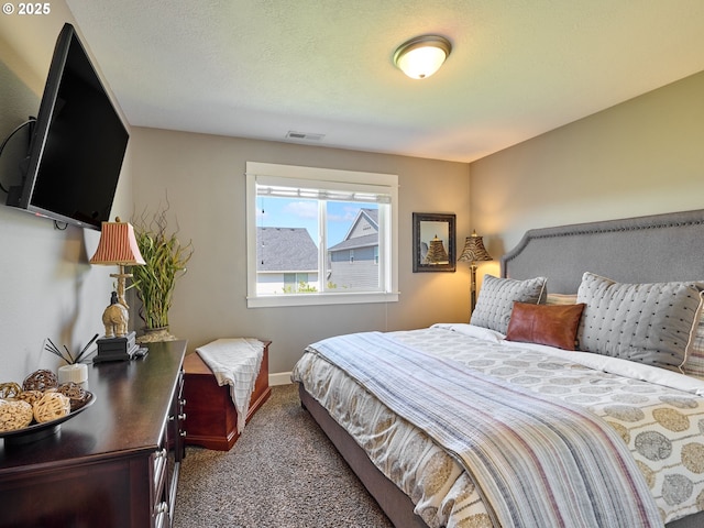 carpeted bedroom with visible vents and baseboards